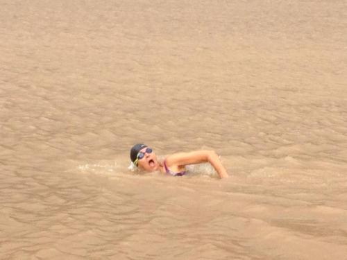 Swimming across the Mekong during rainy season. Wow.